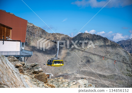 The Diavolezza Cable Car ascends through the stunning Swiss Alps, offering breathtaking views of the Bernina Range and nearby glaciers, ideal for hiking and alpine adventures. 134856152