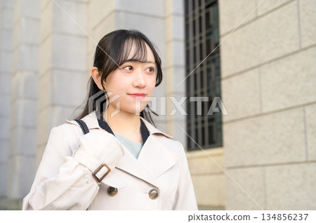 A woman walking through an office district on her way to work 134856237