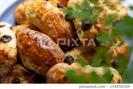 A plate of golden and crispy raisin scones A plate of golden and crispy raisin scones 134856384
