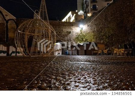 Night view of a quiet outdoor space with decorations and stone walls in a Peniscola, Spain during winter Night view of a quiet outdoor space with decorations and stone walls in a Peniscola, Spain during winter 134856501