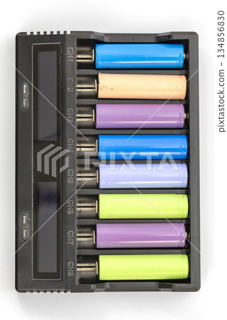 Overhead view of an eight-channel battery charger with batteries of various colors inserted. Overhead view of an eight-channel battery charger with batteries of various colors inserted. 134856830