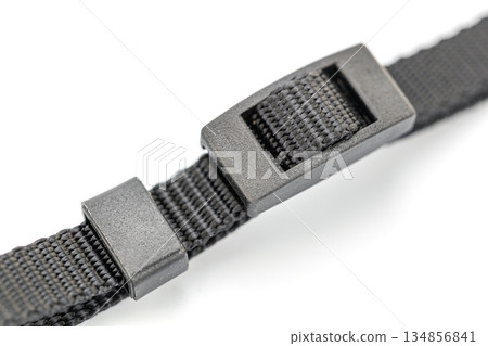 A close-up shot showcases a black nylon strap, featuring a plastic buckle. 134856841