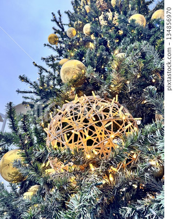 Bright Christmas Tree toys are hanging on the tree. New Year 134856970