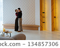 Couples dancing in a modern living space during a cozy evening together 134857306