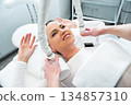 Woman receiving a beauty treatment in a modern wellness center 134857310