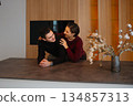 Couple enjoying intimate moment in modern kitchen during winter afternoon 134857313