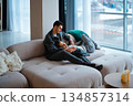 Cozy family moment on a stylish sofa in a modern living room 134857314