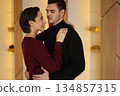 Couple sharing intimate moment in modern indoor space during daytime 134857315