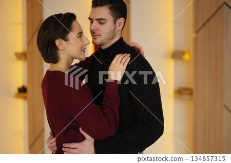 Couple sharing intimate moment in modern indoor space during daytime 134857315