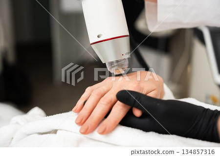 Hand treatment in a skincare clinic during a beauty appointment session 134857316