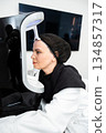 Woman undergoing skincare treatment in modern beauty clinic setting 134857317