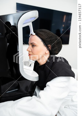 Woman undergoing skincare treatment in modern beauty clinic setting 134857317