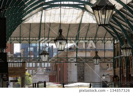 Architecture greco-roman style with iron glass roof and Lanterns hanging on the ceiling in Covent Garden. Architecture greco-roman style with iron glass roof and Lanterns hanging on the ceiling in Covent Garden. 134857326