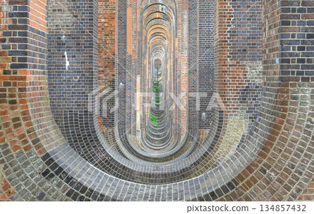 Architectural splendour of Ouse Valley Viaduct or Balcombe Viaduct (Railway viaduct) carries the Brighton Main Line over the River Ouse in Sussex. The semi-circular arches vaulting supporting brick Architectural splendour of Ouse Valley Viaduct or Balcombe Viaduct (Railway viaduct) carries the Brighton Main Line over the River Ouse in Sussex. The semi-circular arches vaulting supporting brick 134857432