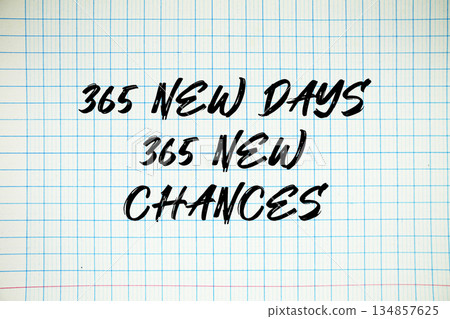 365 New Days 365 New Chances text written on white notebook sheet with grid 134857625