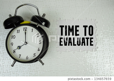 Time to Evaluate text with alarm clock on white background Time to Evaluate text with alarm clock on white background 134857659