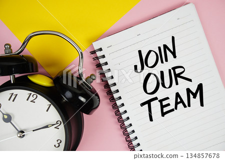 Join Our Team text written on notepad with alarm clock on pink background Join Our Team text written on notepad with alarm clock on pink background 134857678