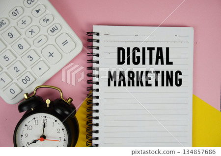 Digital Marketing text written on notepad with calculator and alarm clock on pink background Digital Marketing text written on notepad with calculator and alarm clock on pink background 134857686