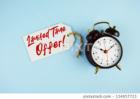 Limited Time Offer! text on price tag with alarm clock on blue background Limited Time Offer! text on price tag with alarm clock on blue background 134857723