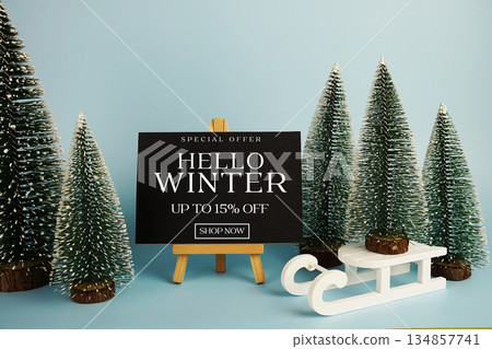 End of Year Sale 15% off text with easel and Christmas tree on blue background End of Year Sale 15% off text with easel and Christmas tree on blue background 134857741