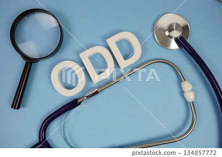 ODD Oppositional Defiant Disorder text with Stethoscope and magnifying glass on blue background ODD Oppositional Defiant Disorder text with Stethoscope and magnifying glass on blue background 134857772