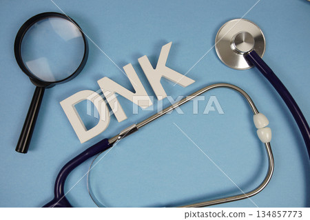 DNK abbreviation of Do Not Know alphabet letters with magnifying glass and stethoscope on blue background DNK abbreviation of Do Not Know alphabet letters with magnifying glass and stethoscope on blue background 134857773