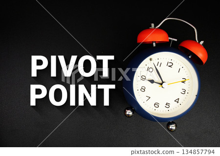 Pivot Point text with alarm clock on black background Pivot Point text with alarm clock on black background 134857794