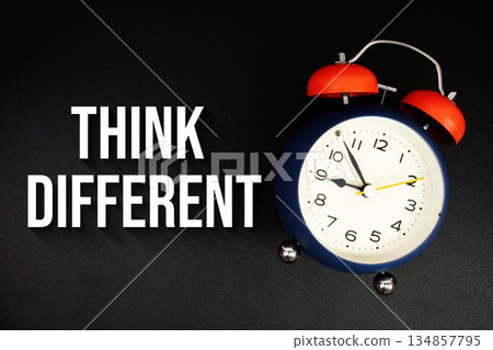 Think Different text with alarm clock on black background Think Different text with alarm clock on black background 134857795