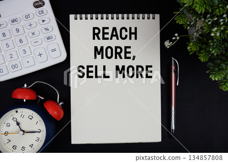 Reach More, Sell More text with calculator with alarm clock on black background Reach More, Sell More text with calculator with alarm clock on black background 134857808