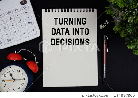 Turning Data Into Decisions text with calculator with alarm clock on black background Turning Data Into Decisions text with calculator with alarm clock on black background 134857809