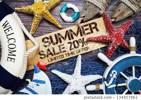 Summer Sale 20% off text on wooden sign decorated with marine nautical on a wooden background 134857861