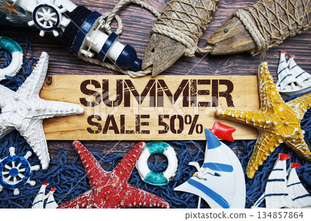 Summer Sale 50% off text on wooden sign decorated with marine nautical on a wooden background 134857864
