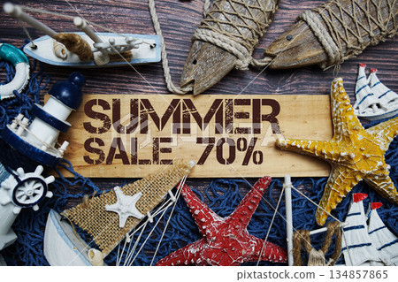 Summer Sale 70% off text on wooden sign decorated with marine nautical on a wooden background Summer Sale 70% off text on wooden sign decorated with marine nautical on a wooden background 134857865