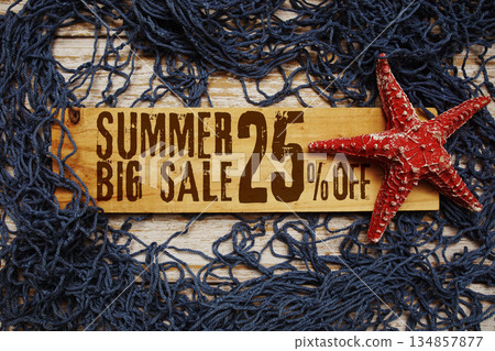 Summer Big Sale 25% off text on wooden sign decorated with Starfish and net on a wooden background 134857877