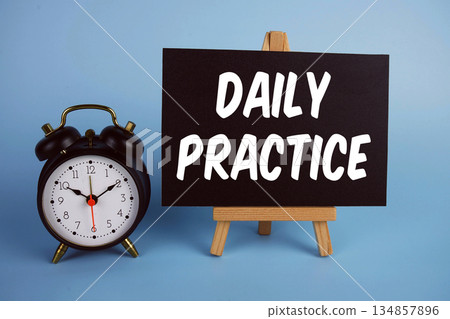 Daily Practice text with easel and alarm clock on blue background 134857896