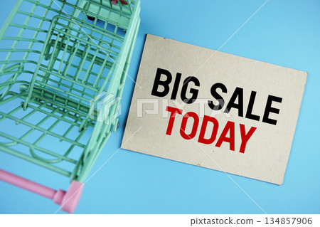 Big Sale Today text on paper card with trolley shopping cart on blue background 134857906