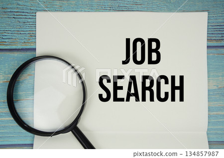 Job Search text written on notepad with magnifying glass flat lay on wooden background Job Search text written on notepad with magnifying glass flat lay on wooden background 134857987
