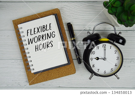 Flexible Working Hours text written on notepad with alarm clock on wooden background 134858013