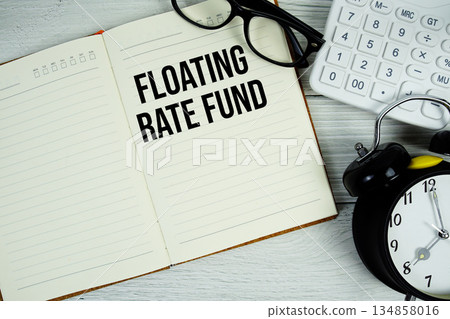Floating Rate Fund text on notepad with alarm clock, magnifying glass and calculator on wooden background Floating Rate Fund text on notepad with alarm clock, magnifying glass and calculator on wooden background 134858016