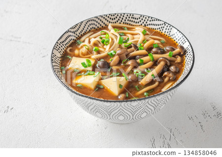 Japanese udon soup with Shimeji mushrooms, tofu, and rich dark umami broth Japanese udon soup with Shimeji mushrooms, tofu, and rich dark umami broth 134858046