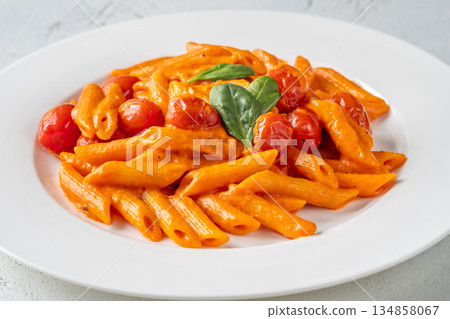 Penne pasta with roasted bell pepper emulsion cherry tomatoes Parmesan and herbs Penne pasta with roasted bell pepper emulsion cherry tomatoes Parmesan and herbs 134858067