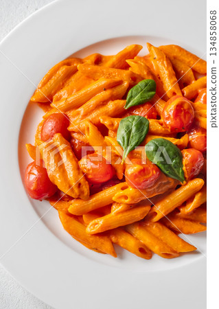 Penne pasta with roasted bell pepper emulsion cherry tomatoes Parmesan and herbs Penne pasta with roasted bell pepper emulsion cherry tomatoes Parmesan and herbs 134858068