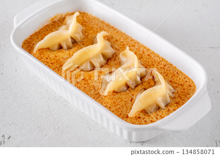 Gyoza dumplings served in creamy Tom Yum sauce with elegant minimalist presentation Gyoza dumplings served in creamy Tom Yum sauce with elegant minimalist presentation 134858071