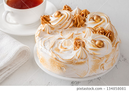 Madonna honey cake topped with toasted meringue and golden decorations flat lay 134858081