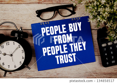 People Buy From People They Trust text with alarm clock and calculator on wooden background 134858517