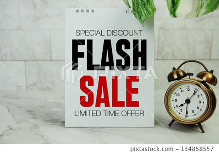 Flash Sale text with alarm clock on marble background Flash Sale text with alarm clock on marble background 134858557