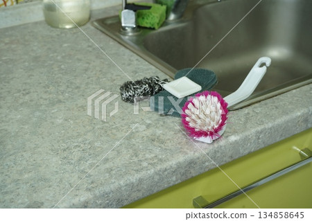 Soap dishwashing brush sponge for dishes near the kitchen sink 134858645