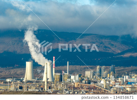 Aerial view of chemical plant. Smoking chimneys from factory. Chimneys of big factory polluting environment Aerial view of chemical plant. Smoking chimneys from factory. Chimneys of big factory polluting environment 134858671