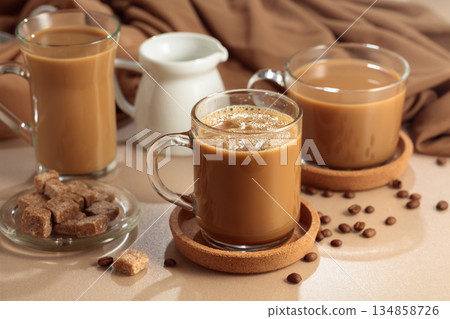 Latte with brown sugar on a beige background. 134858726