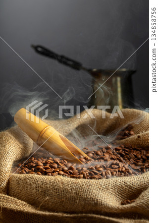 Fresh roasted coffee beans in burlap bag. Fresh roasted coffee beans in burlap bag. 134858756